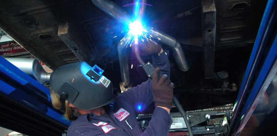 Technician working below a car - Leon's Car Care Center