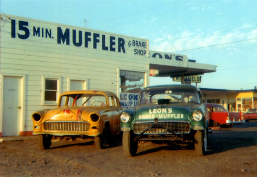 Leon's Car Care Center at sunset with 2 cars in front